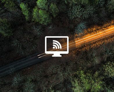 Drone view above a road through forest road 