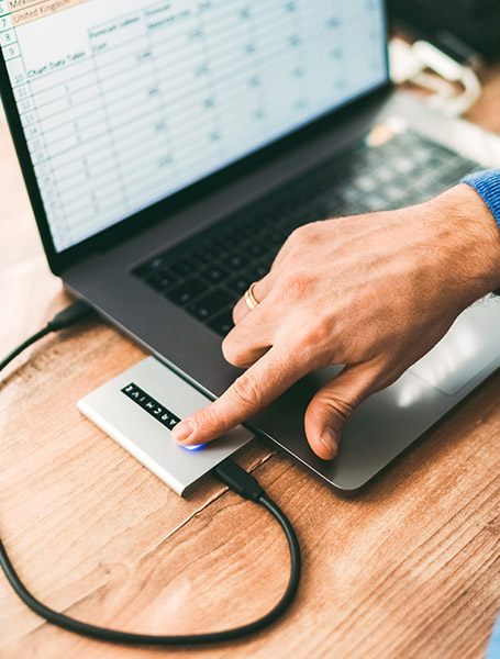 man at work unlocking external hard disk drive with fingerprint